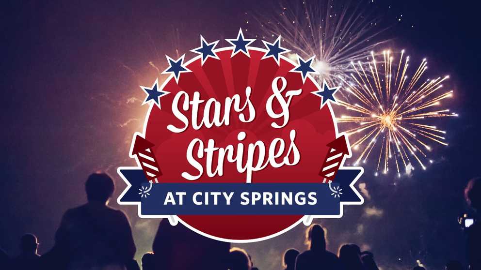 Stars & Stripes at City Springs - A crowd watches as a bright yellow firework explodes in the sky