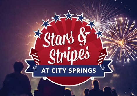 Stars & Stripes at City Springs - A crowd watches as a bright yellow firework explodes in the sky