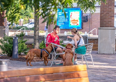 Man and woman eating in the plaza